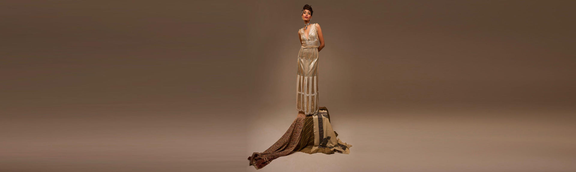 Woman in a long, elegant dress on a plain background